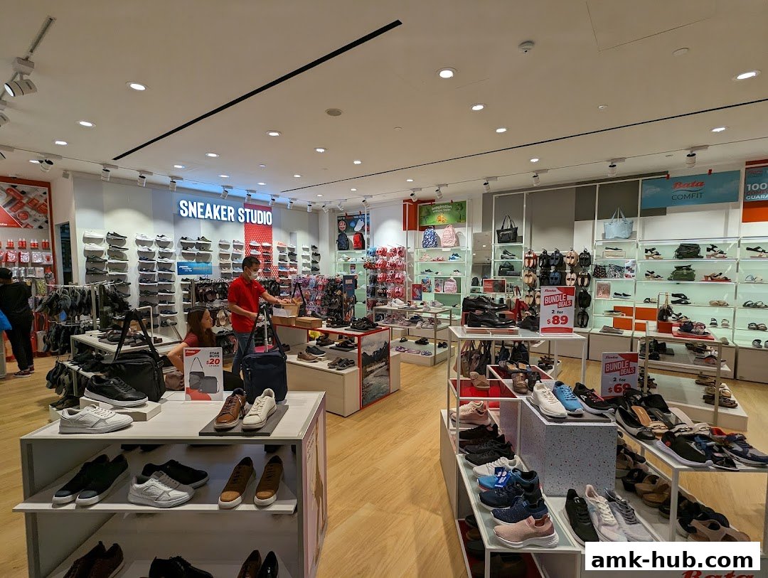Interior view of a Bata shoe store with various footwear displayed on shelves and stands.