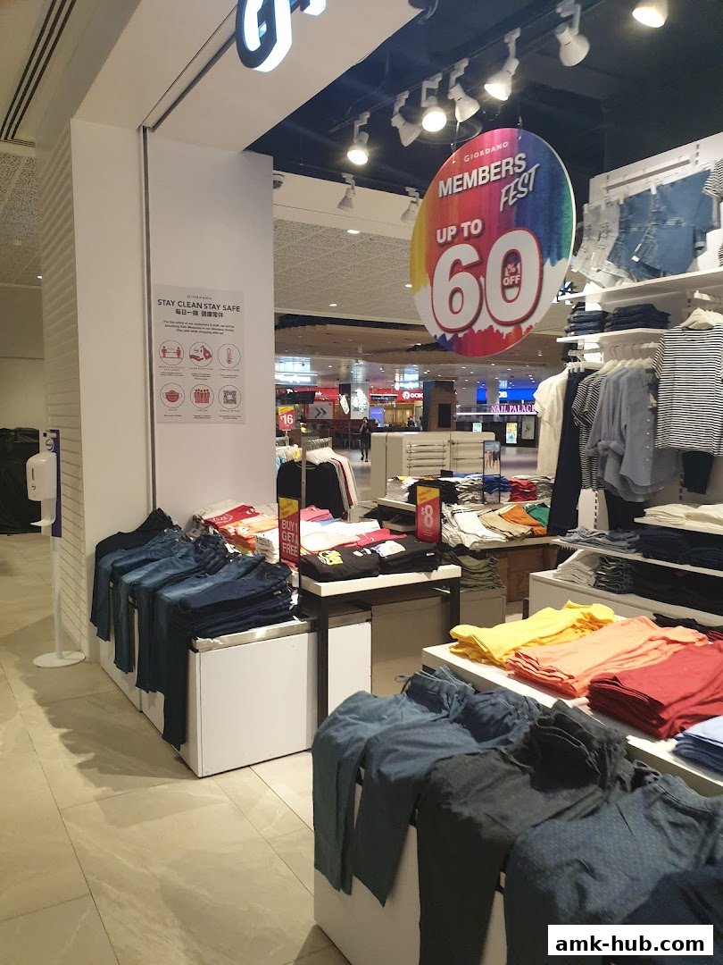 Giordano store interior featuring colorful t-shirts and jeans, with a 'Members Fest' promotion.