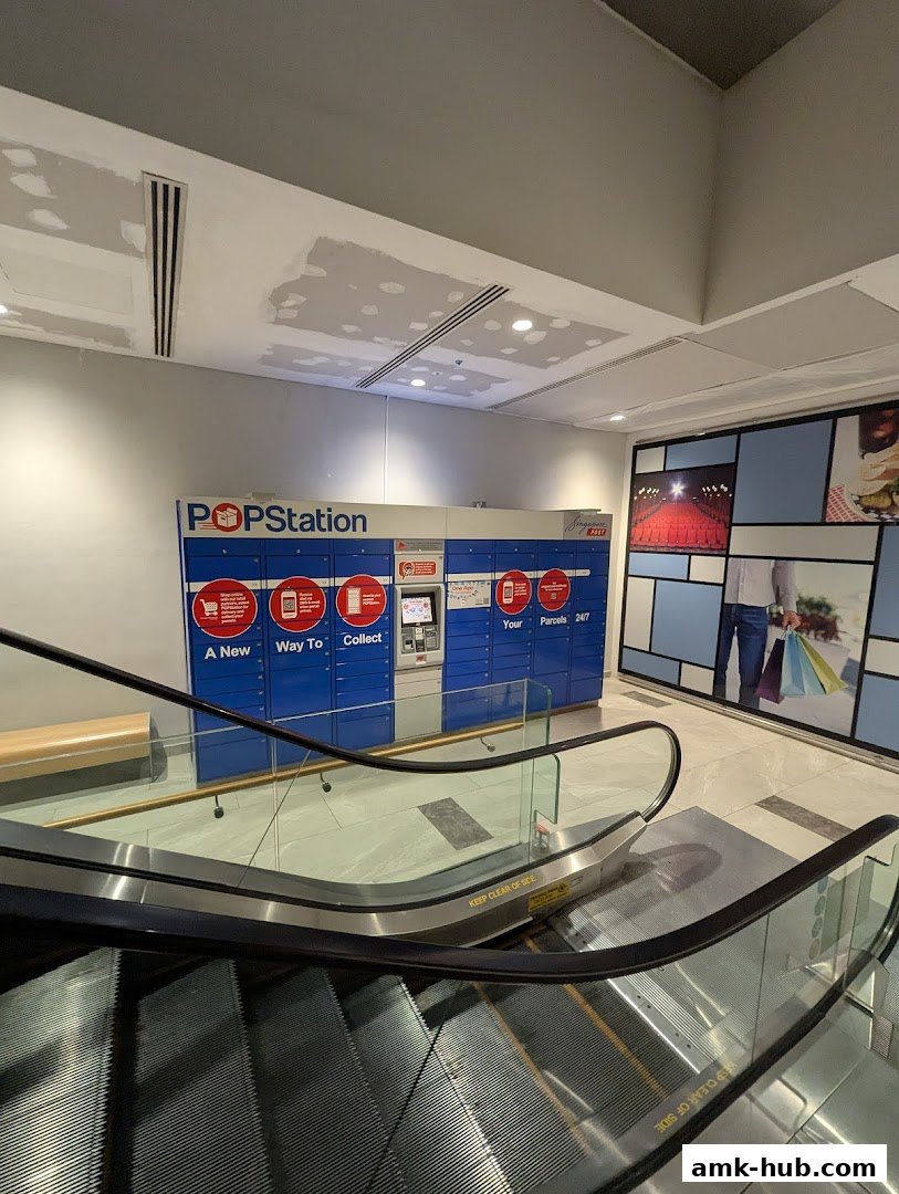POPStation parcel lockers are visible next to an escalator in a shopping mall.