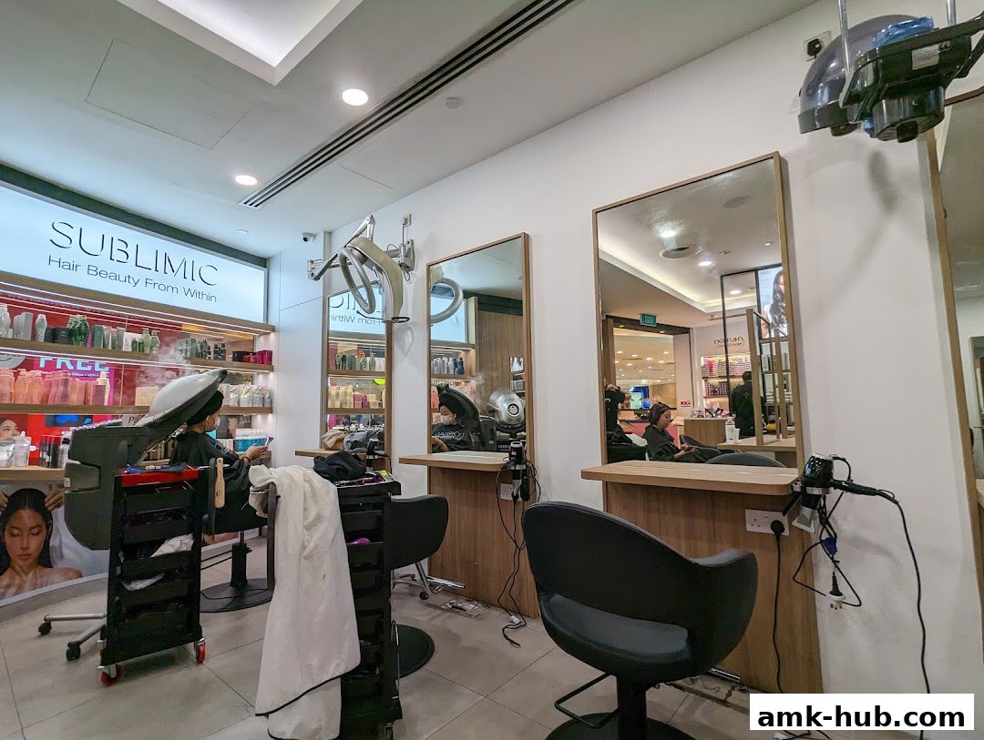 Interior of a hair salon with clients receiving treatments and shelves of hair products.