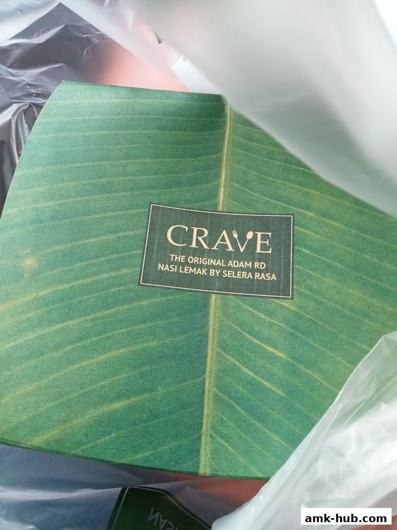 A green box with a banana leaf design and the Crave Nasi Lemak logo.