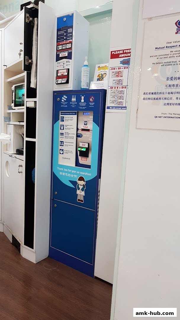 A ticket vending machine and a notice board with pricing information.