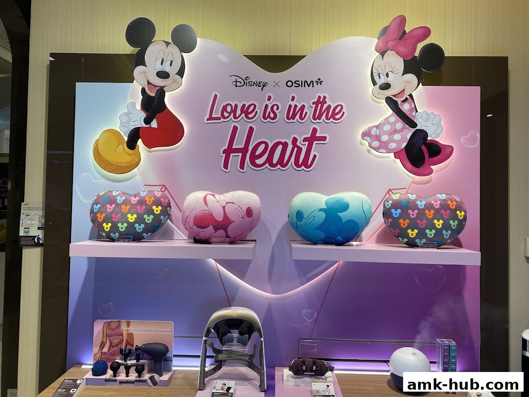 OSIM shop display featuring Disney characters Mickey and Minnie with heart-shaped pillows and massage products.