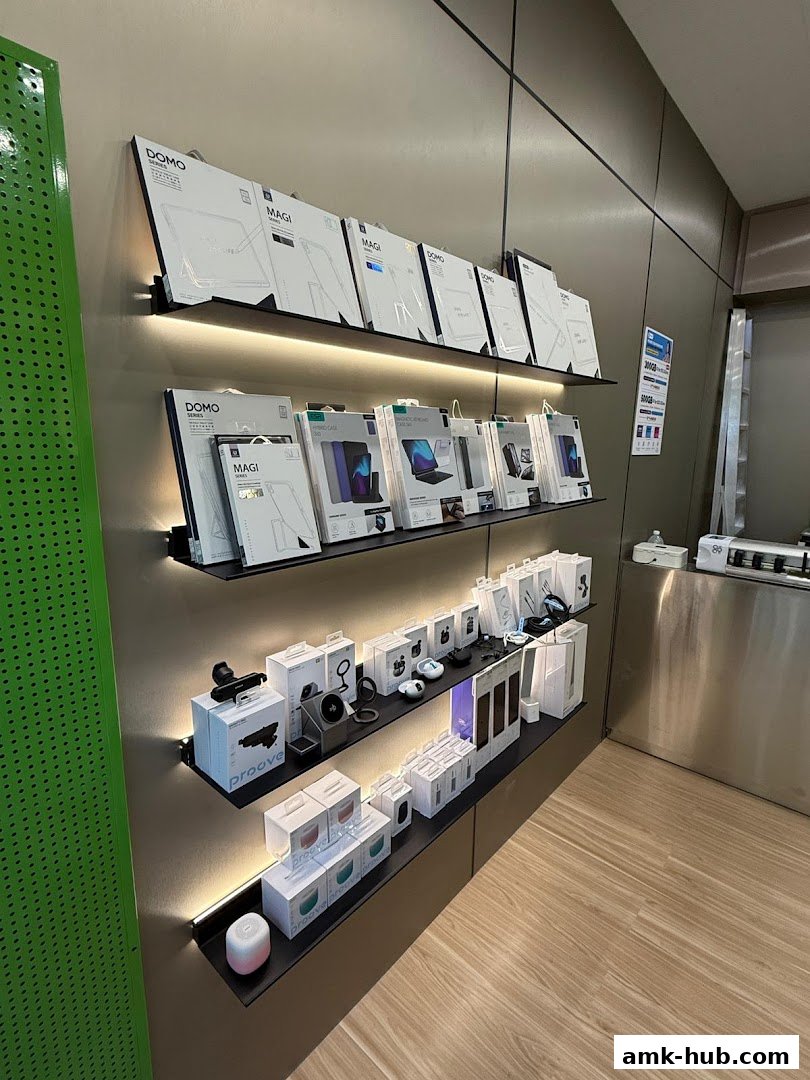 Shelves display various tech accessories like tablet cases, chargers, and earbuds in modern packaging.