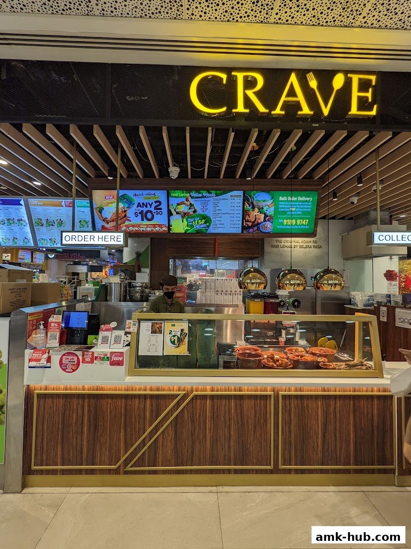 The front of a Crave Nasi Lemak shop with a menu board and display counter.