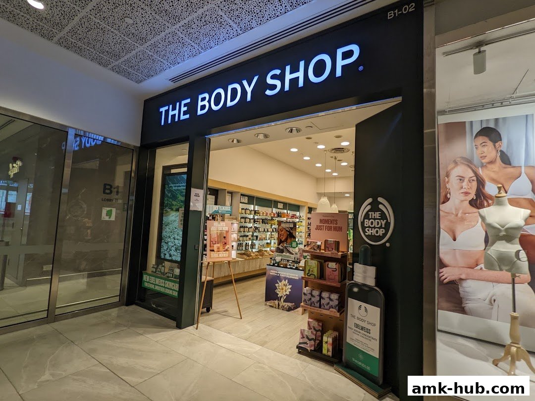 The entrance to The Body Shop store, featuring its prominent signage and product displays.