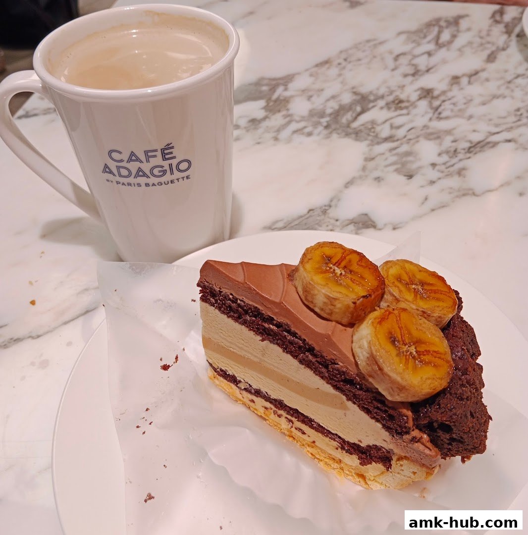A slice of chocolate banana cake and a cup of coffee on a marble table.