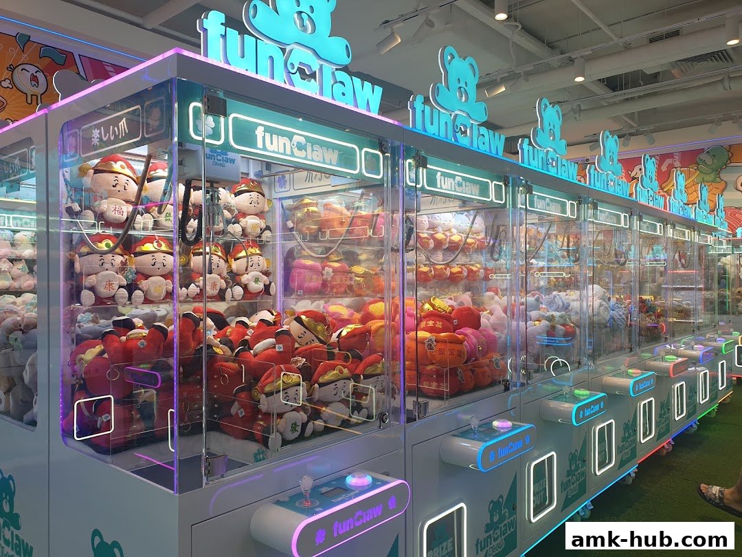 A row of brightly lit claw machines filled with plush toys, branded as 'Fun Claw'.