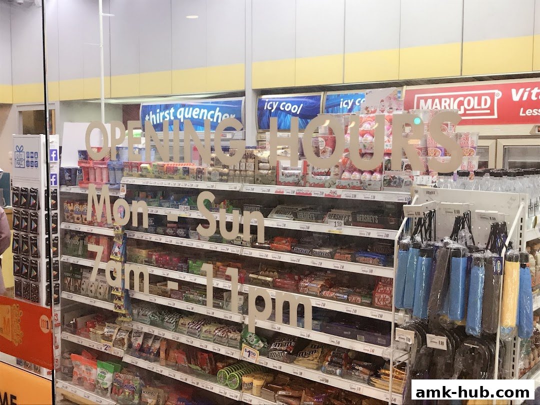 A shop interior displaying shelves stocked with snacks, chocolates, and umbrellas, with opening hours visible.