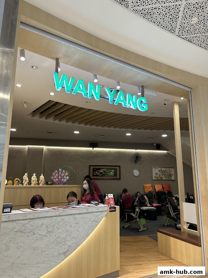 The entrance to Wan Yang Health Product and Foot Reflexology Centre with staff at the reception.