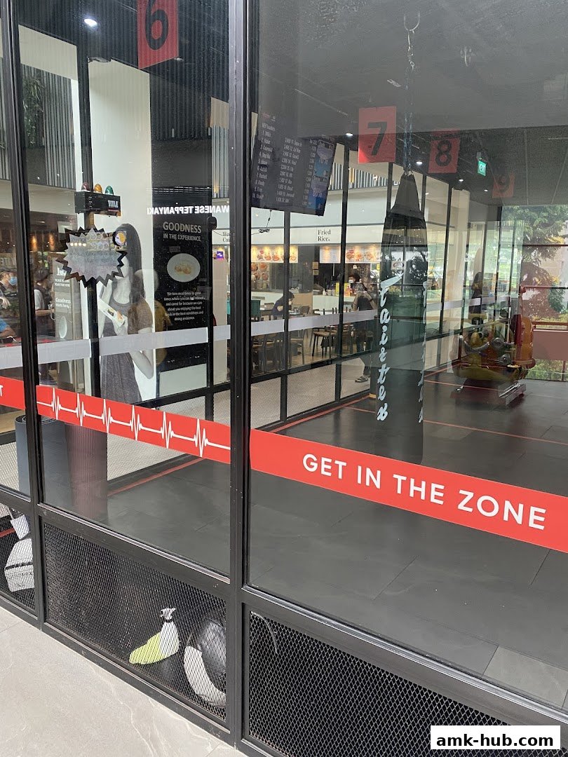 Shop front with a punching bag and fitness equipment visible inside.
