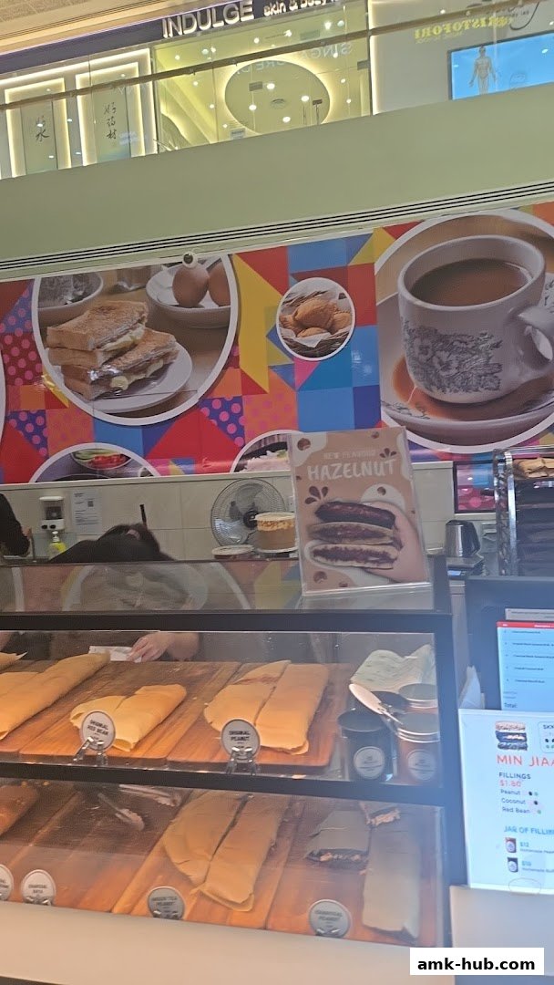 A display case filled with various types of pancakes and a menu board.