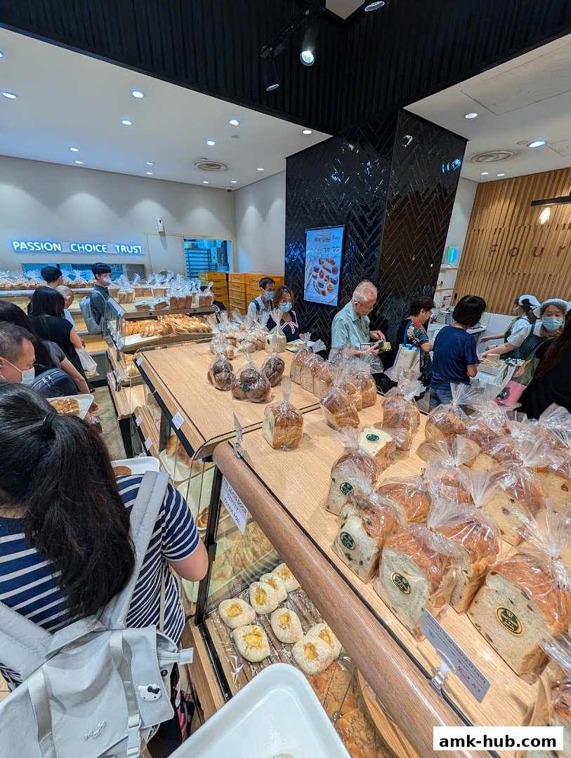 Customers browse a wide selection of freshly baked bread and pastries at Four Leaves bakery.