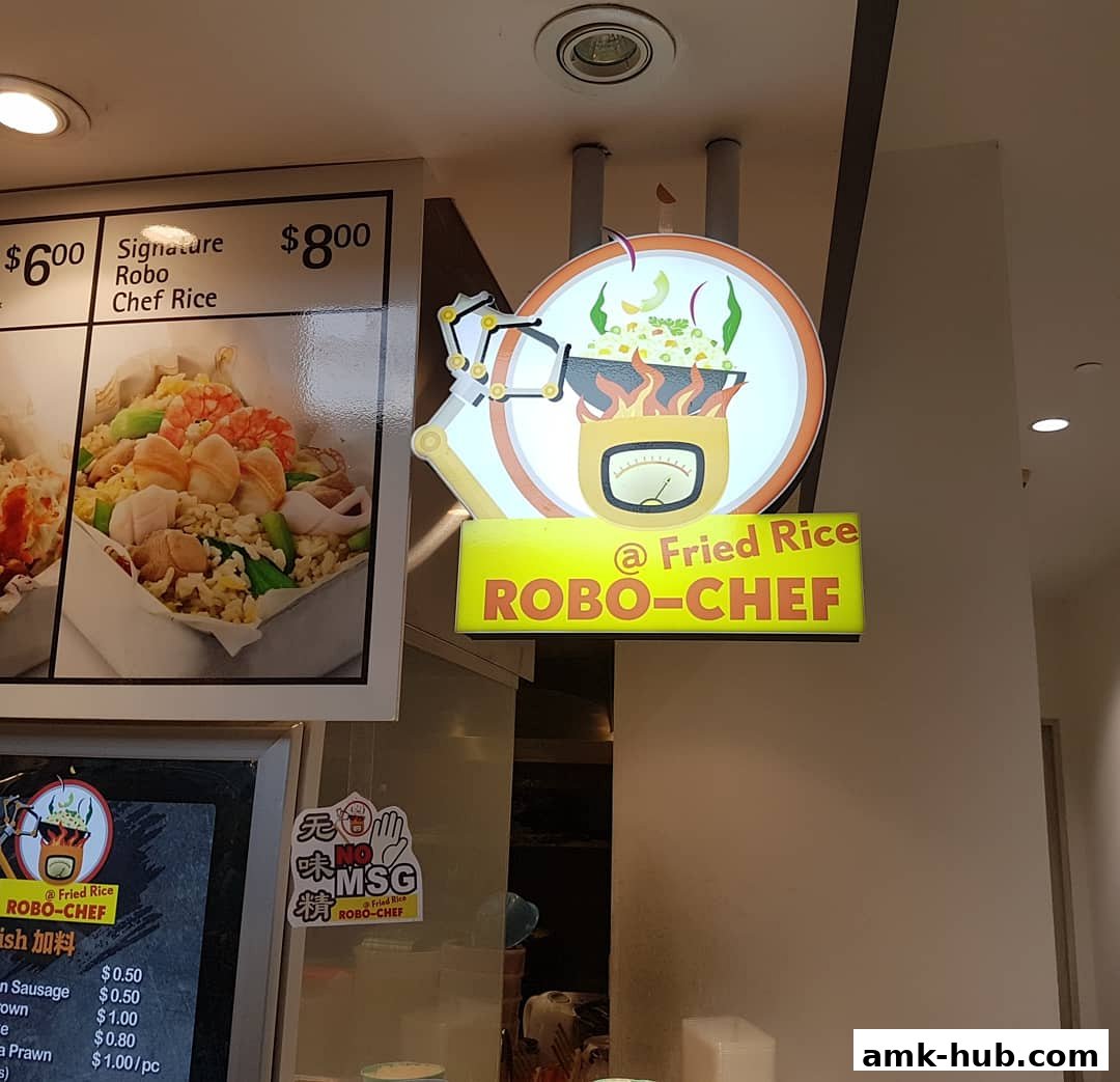 A sign for 'Fried Rice ROBO-CHEF' with a robotic arm cooking food and a menu board.