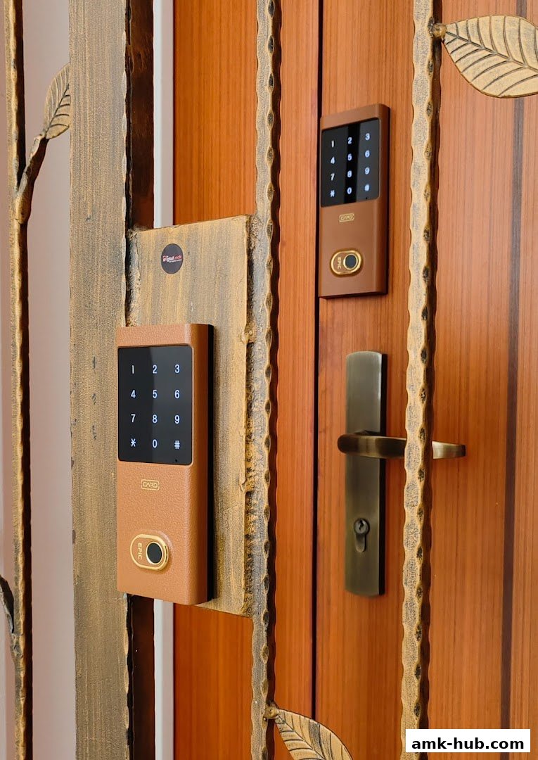 Close-up of two digital door locks with keypads and fingerprint scanners on a wooden door.