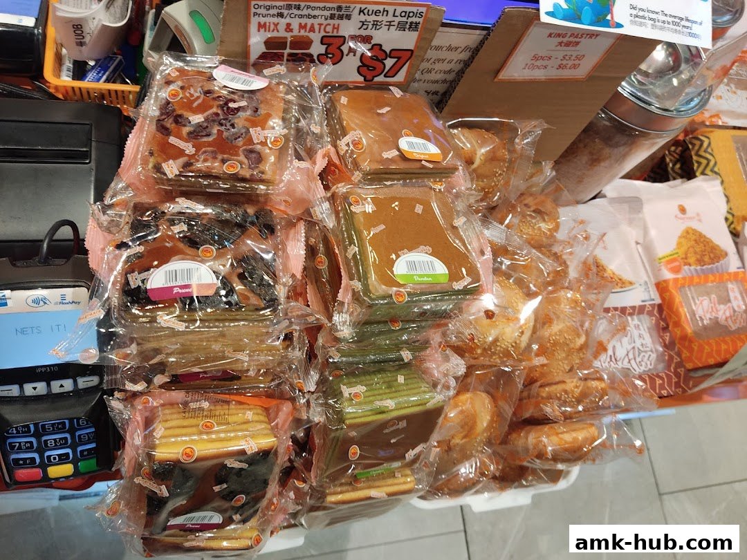 A variety of individually wrapped pastries and baked goods are displayed for sale.