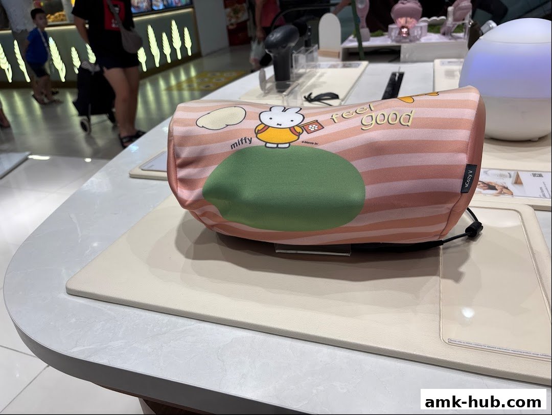 A Miffy-themed neck pillow with 'feel good' text displayed in a retail store.