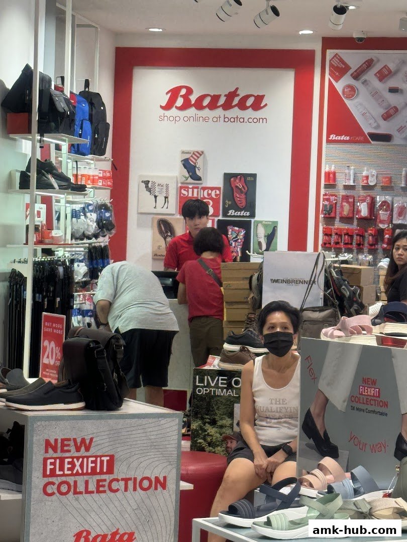 Interior of a Bata shoe store with displays of shoes, bags, and promotional signage.