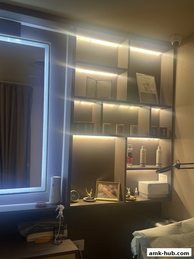 A well-lit shelf display with beauty products and decorative items in a salon.