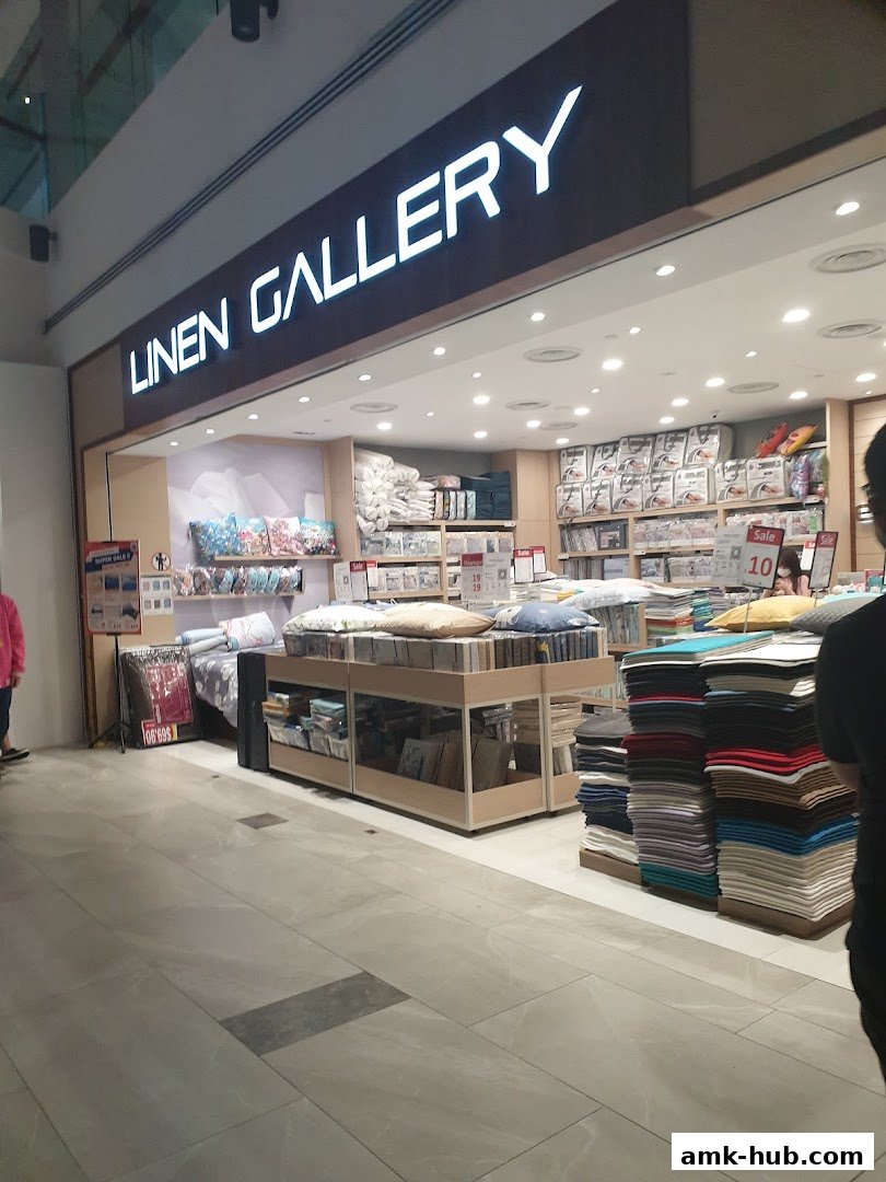 The exterior of a Linen Gallery shop showcasing bedding and home textiles.