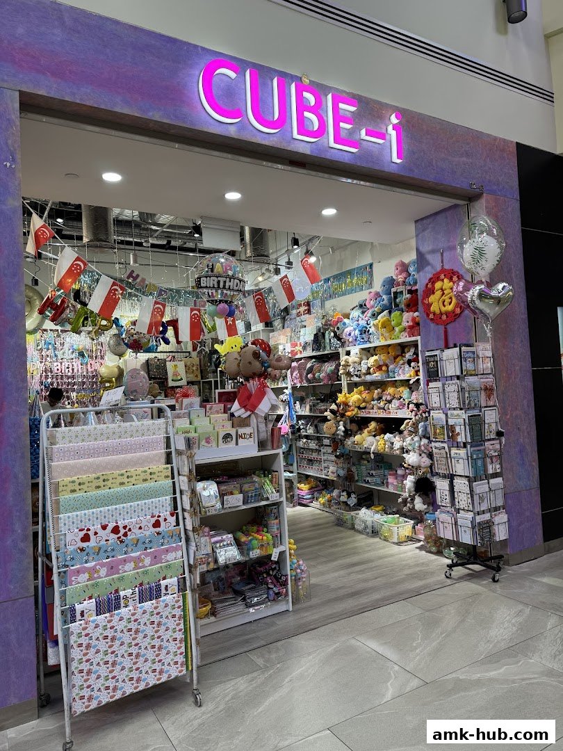 The CUBE-i shop front displays a wide variety of gifts, party supplies, and plush toys.