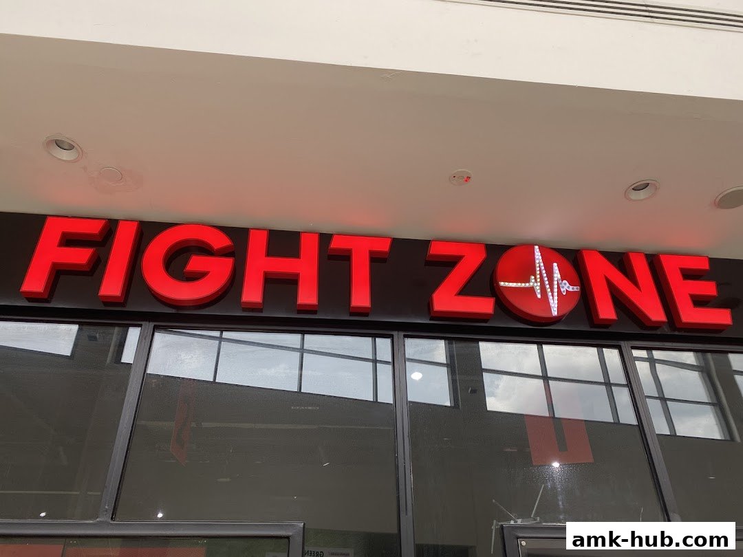 The illuminated red sign for 'FIGHT ZONE' is displayed above the shop's entrance.