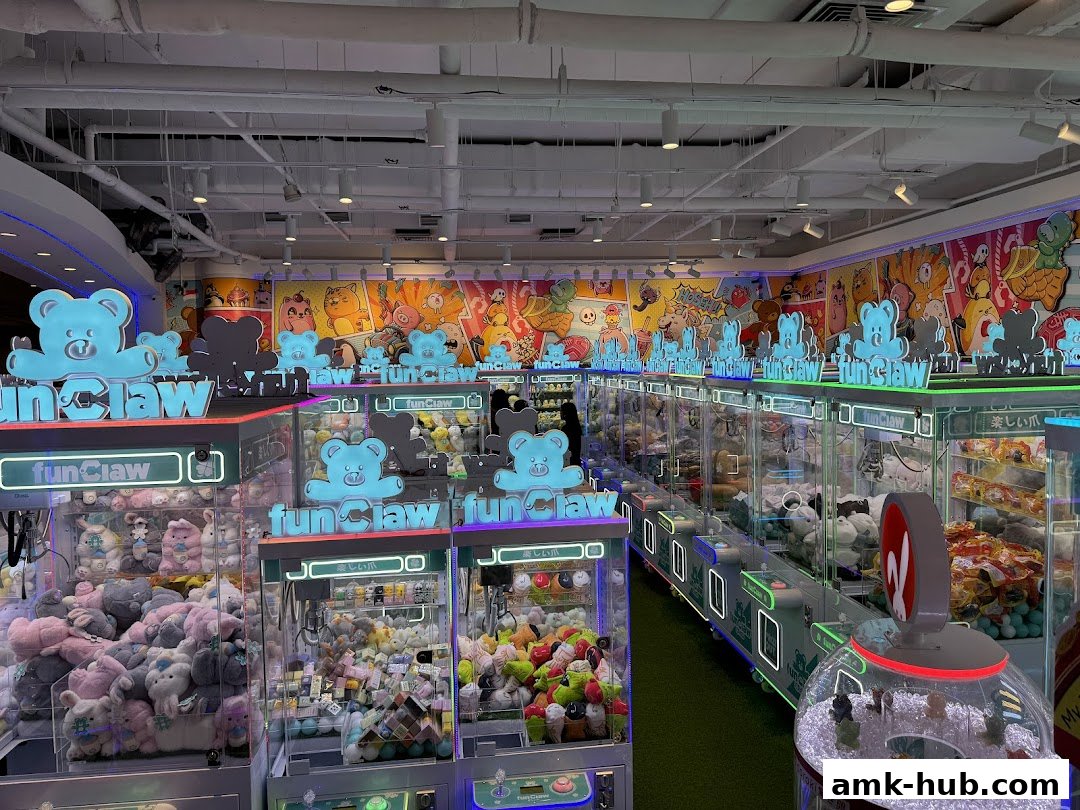 Interior of a brightly lit arcade with multiple claw machines filled with plush toys.