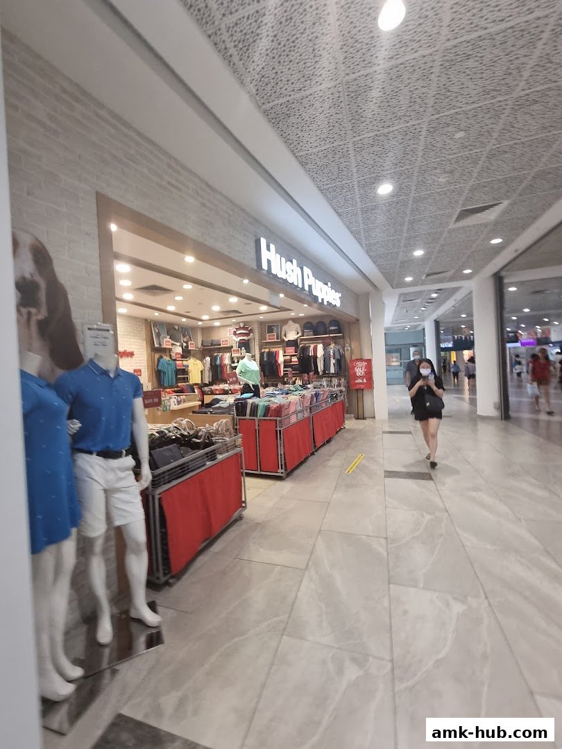 The Hush Puppies store entrance with mannequins and clothing displays.