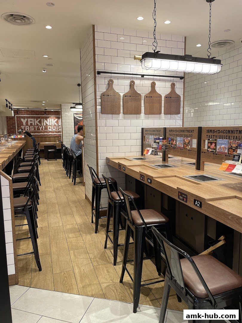 Interior of a Yakiniku Like restaurant with counter seating and grilling stations.