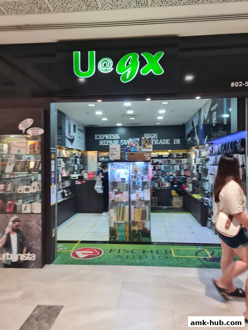 The entrance of a shop named UGX, selling mobile accessories and offering repair services.