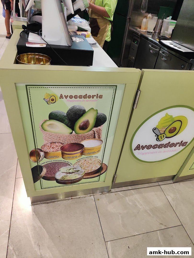Avocadoria shop counter with a display of avocado desserts and the shop logo.