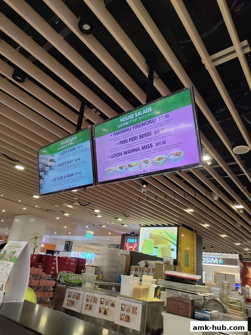 Digital menus displaying sushi and house salad options at Maki-San AMK Hub.