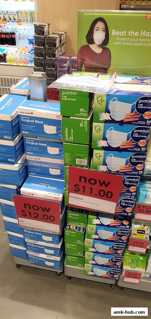A display of surgical masks with promotional pricing at Guardian.