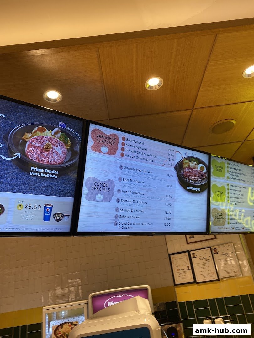 A digital menu board displaying various Japanese classic dishes and combo specials at Pepper Lunch.