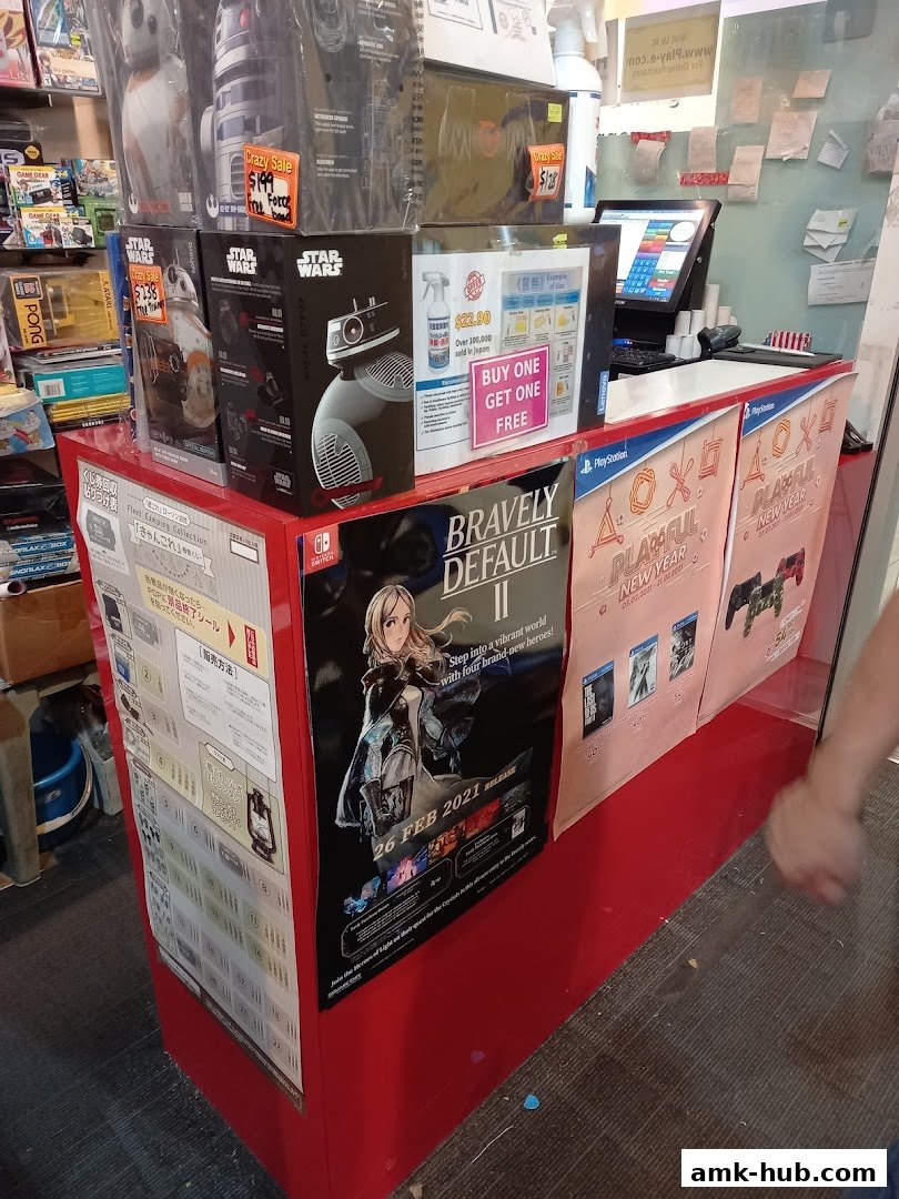 A retail counter displaying Star Wars merchandise, video games, and promotional posters.