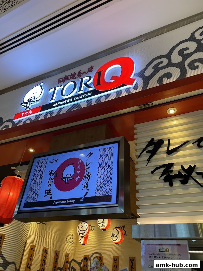 The TORI-Q Japanese Yakitori shop front with illuminated signage and a digital display.