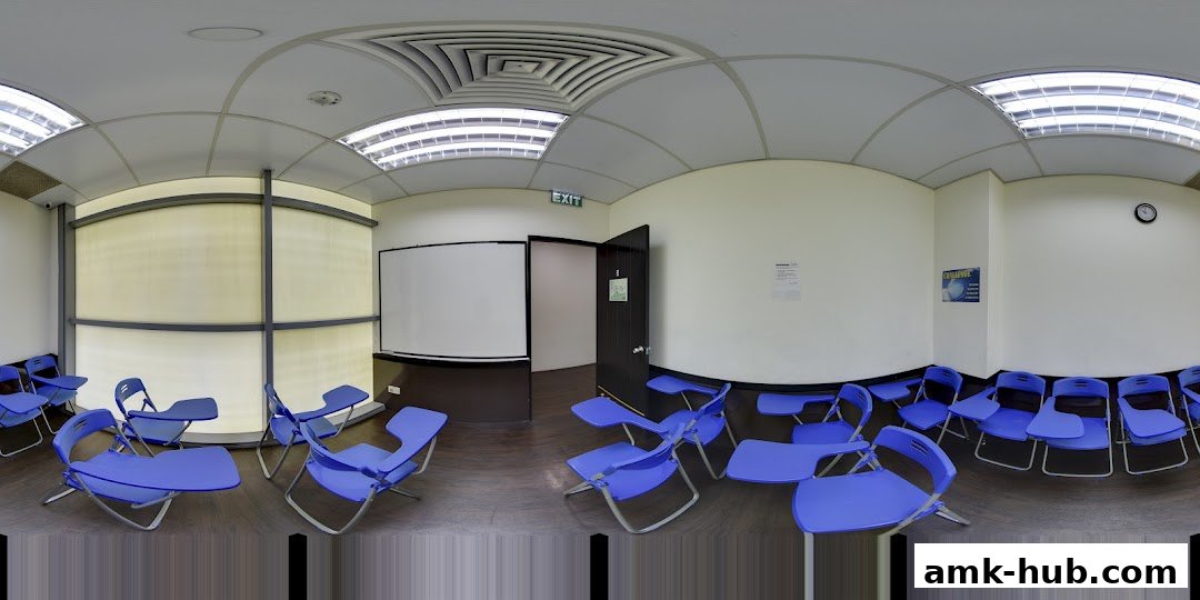 A classroom or meeting room with blue chairs and a whiteboard.