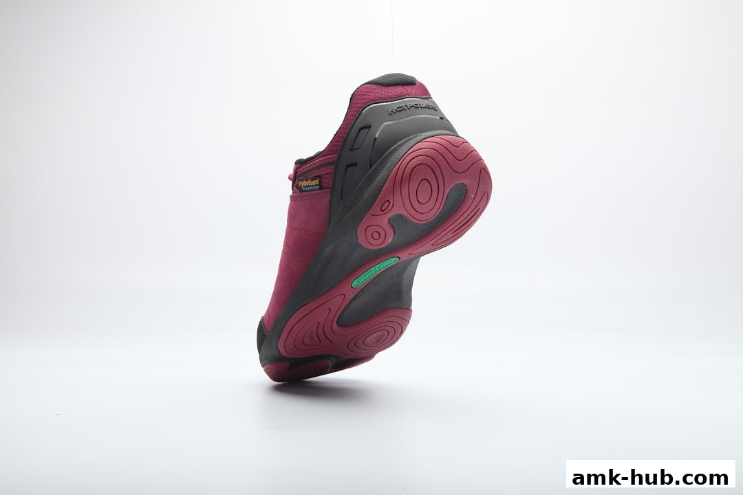 A close-up shot of a maroon and black shoe, showcasing its sole and branding.