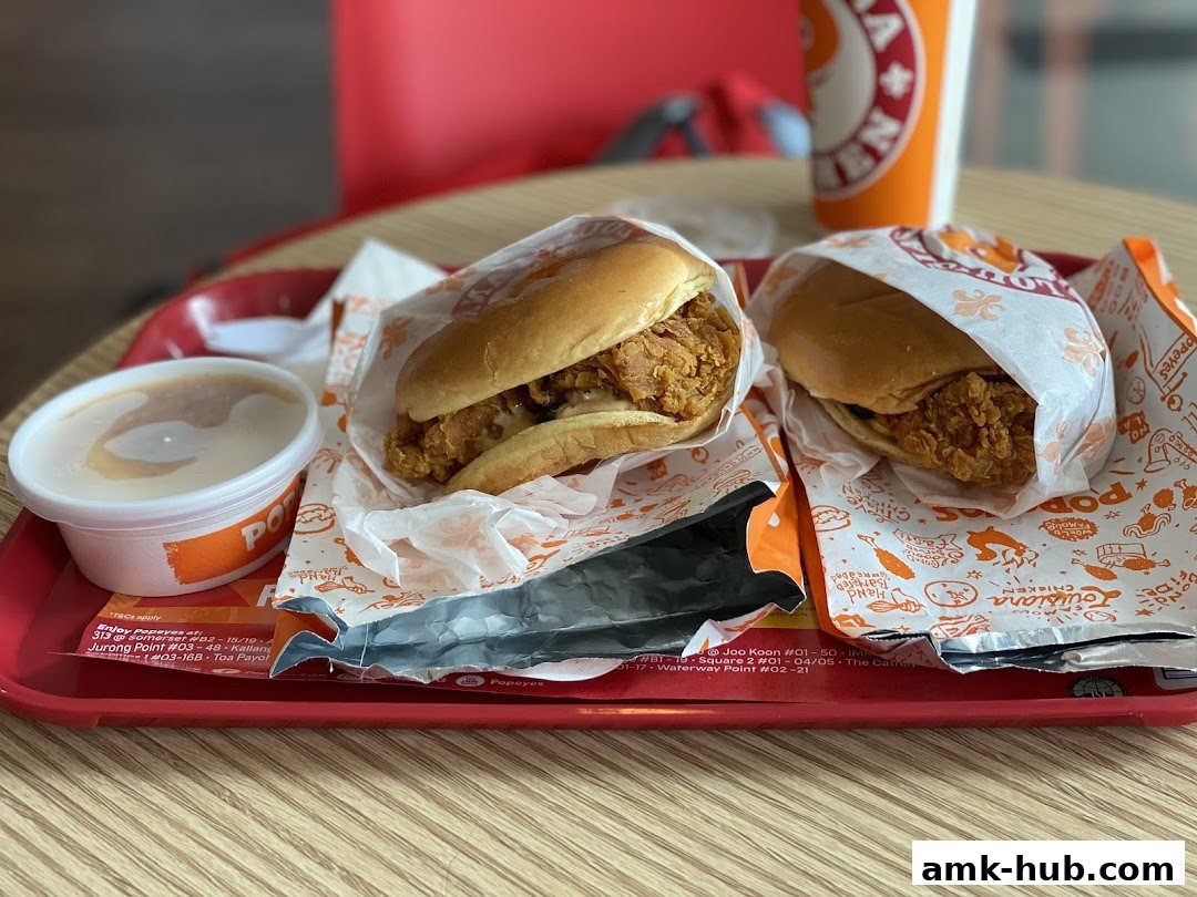 A tray of Popeyes fried chicken sandwiches and a side of mashed potatoes.