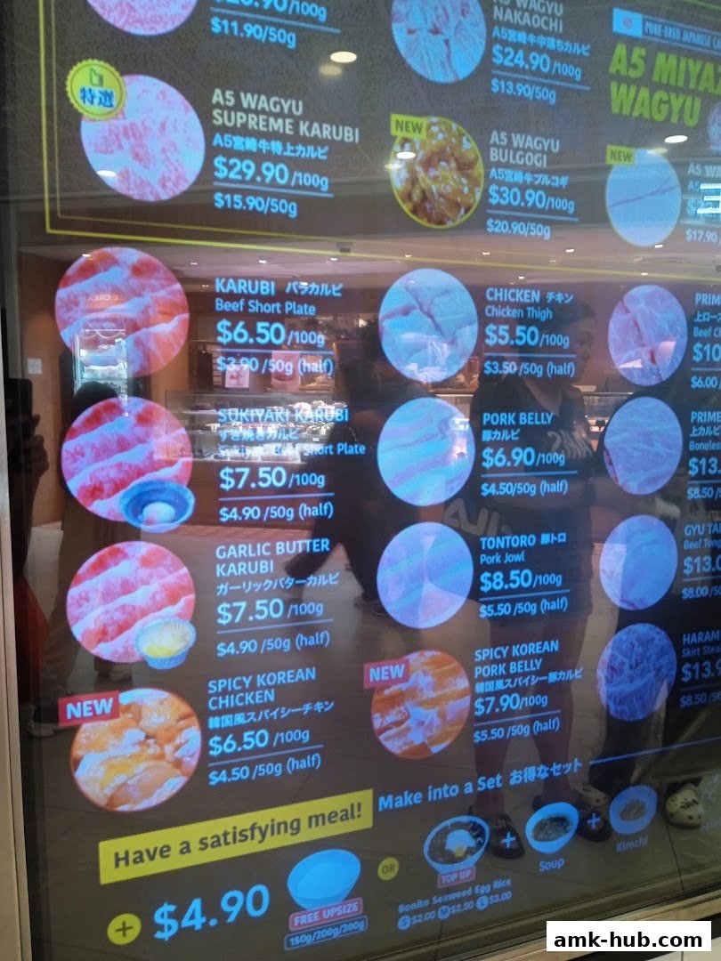 A digital menu displaying various cuts of Wagyu beef, chicken, and pork belly with prices.