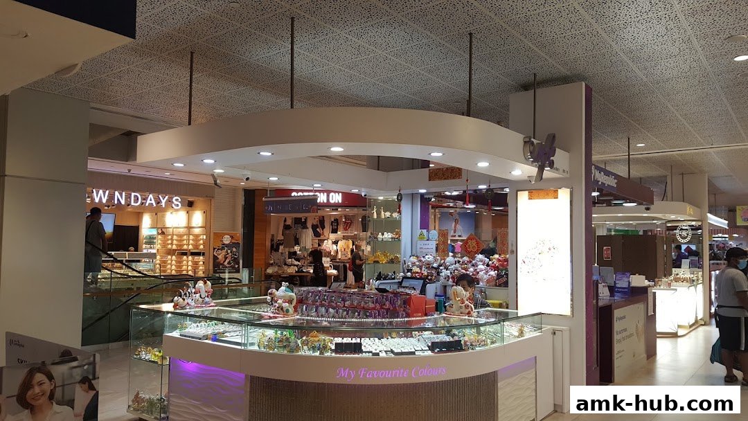 A brightly lit jewelry store with display cases filled with items and other shops visible in the background.
