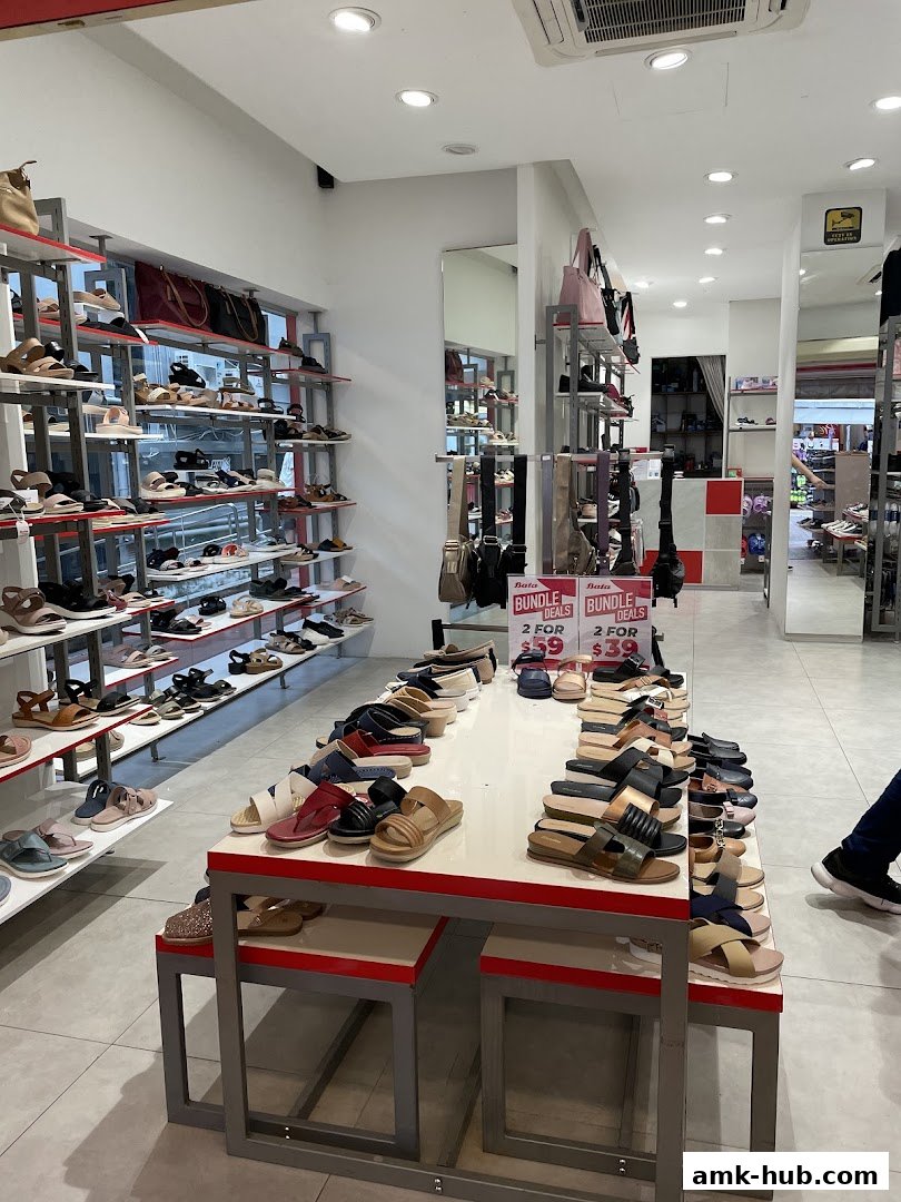 Interior view of a Bata shoe store showcasing a wide variety of sandals and bags on display.