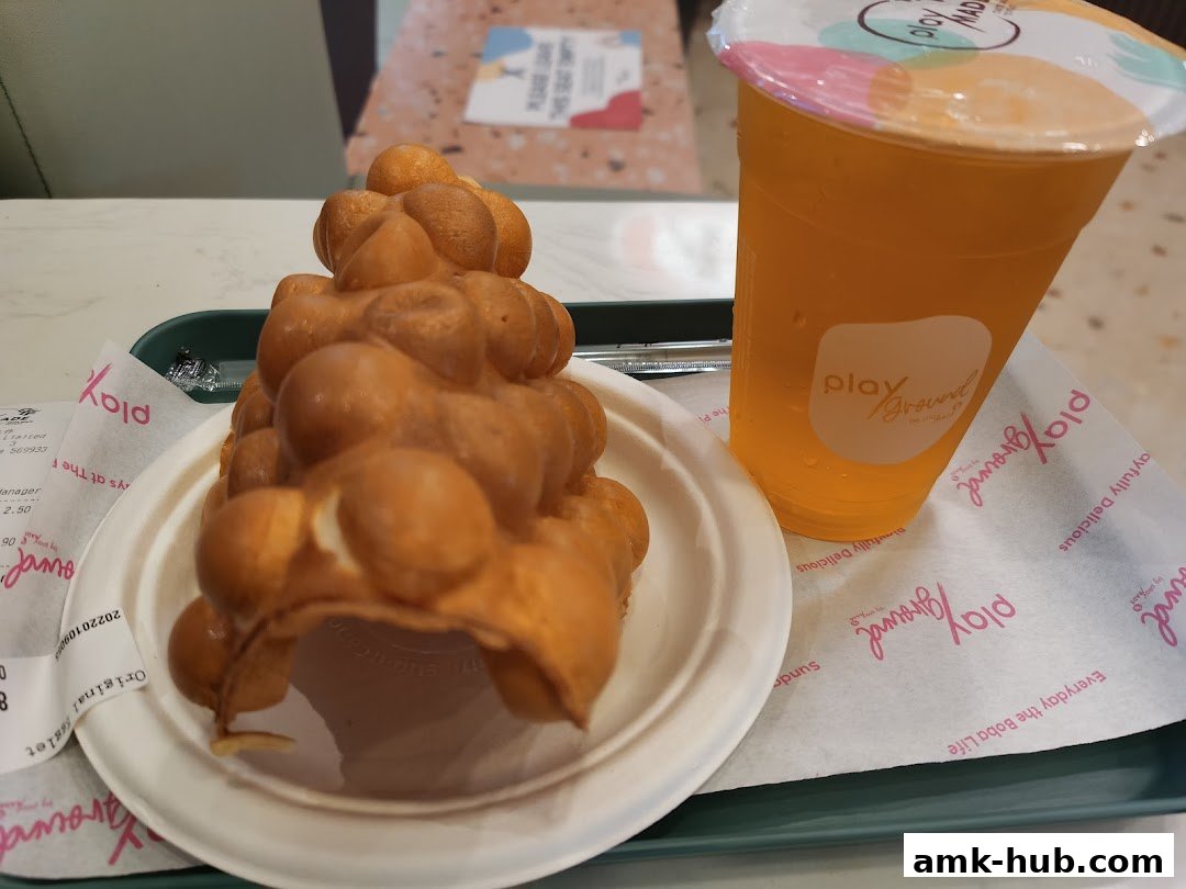 A bubble waffle and an orange drink from Playground by PlayMade.