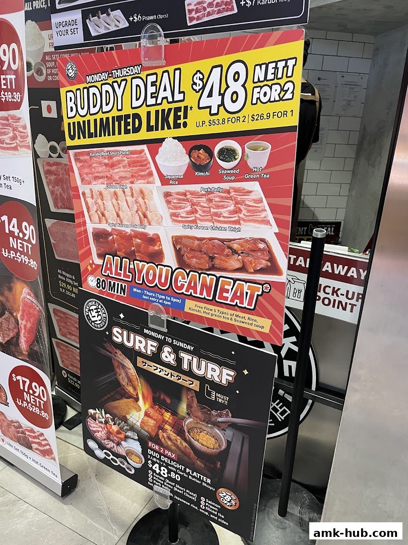 Promotional signs for Yakiniku Like AMK Hub featuring a Buddy Deal and a Surf & Turf platter.