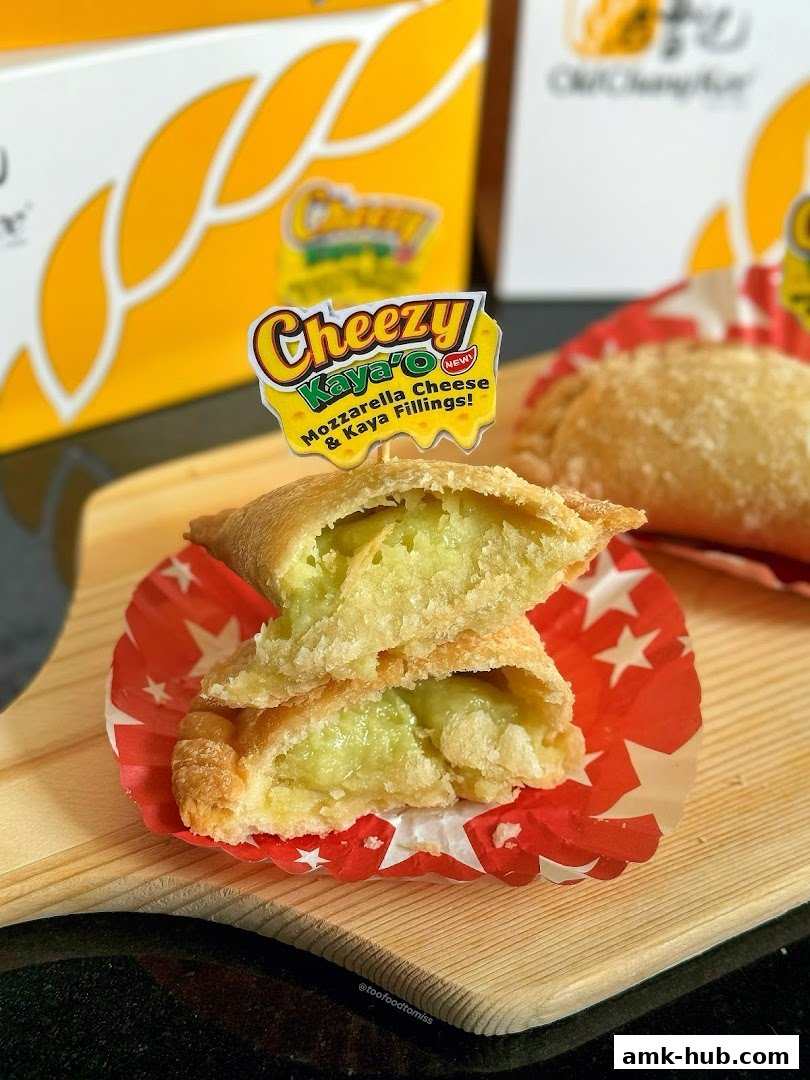 A close-up of a Cheezy Kaya O pastry, split open to reveal its filling.