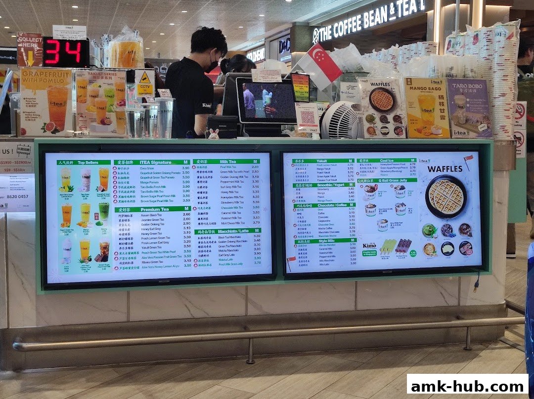 A digital menu board displaying various iTEA drinks, milk teas, smoothies, coffees, and waffles with prices.
