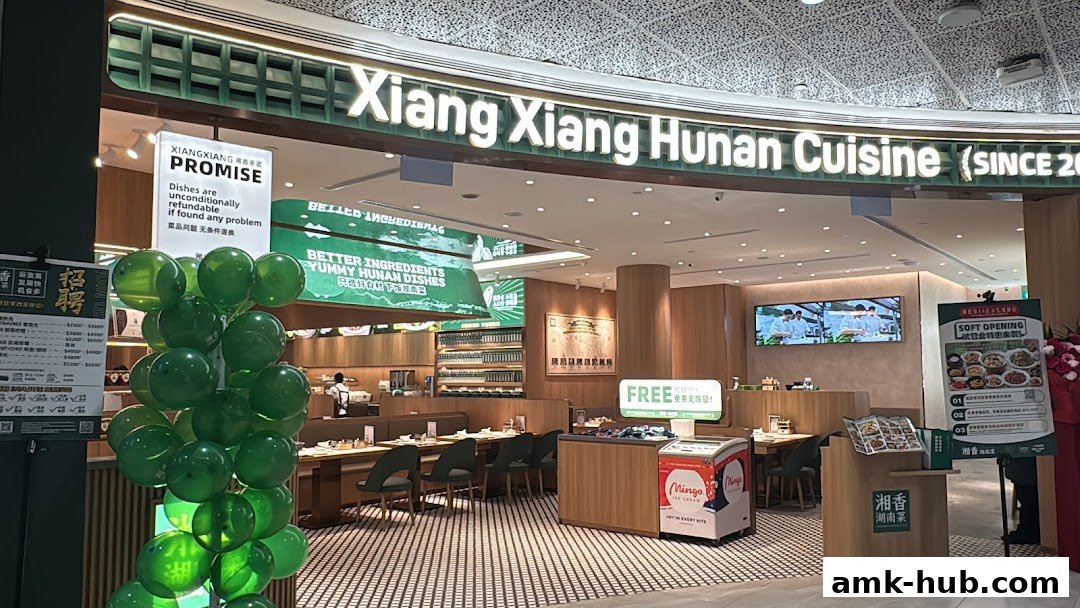 The entrance of Xiang Xiang Hunan Cuisine restaurant with green balloons and promotional signs.