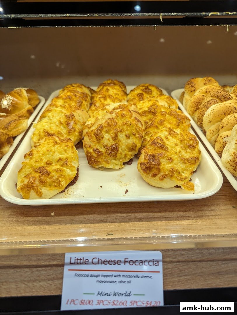A display of freshly baked Little Cheese Focaccia with golden-brown cheese topping.