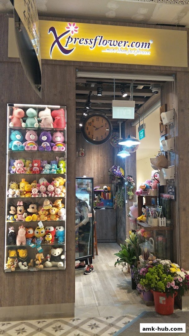 The entrance of Xpressflower shop, showcasing plush toys and floral arrangements.