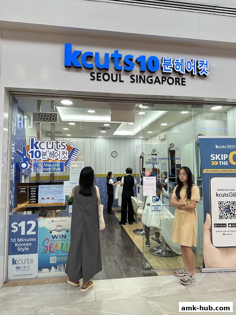 The entrance of a K-cuts hair salon with staff and customers visible inside.